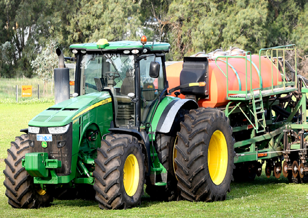 once large green tractor in a field. 